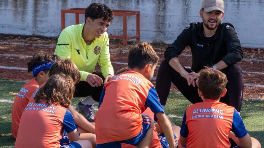 Coaches discussing strategies with young soccer players at Altın Genç Futbol Akademi, İzmir.
